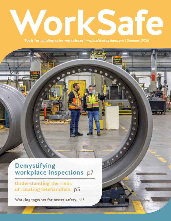 Cover of WorkSafe magazine Summer 2026 featuring a large circular industrial metal component in the foreground framing two workers in high‑visibility safety vests standing and talking inside a manufacturing facility. The cover includes text: ‘WorkSafe,’ ‘Tools for building safer workplaces,’ and article highlights on workplace inspections, rotating telehandlers, and improving workplace safety.